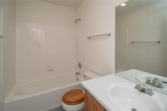 full bathroom with toilet, tiled shower / bath, and vanity