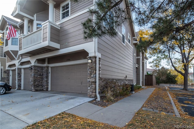 view of side of home with a balcony and a garage