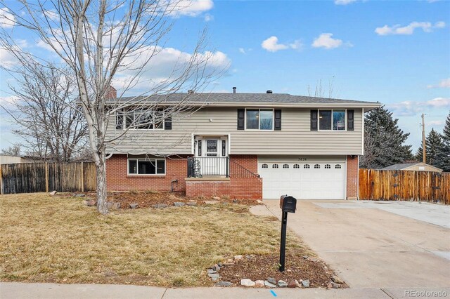7636 S Eaton Way, Littleton, CO 80128 - bi-level home with brick siding, concrete driveway, a garage, and a chimney