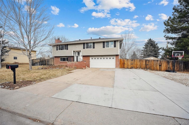 7636 S Eaton Way, Littleton, CO 80128 - split foyer home featuring a chimney, concrete driveway, brick siding, and a garage