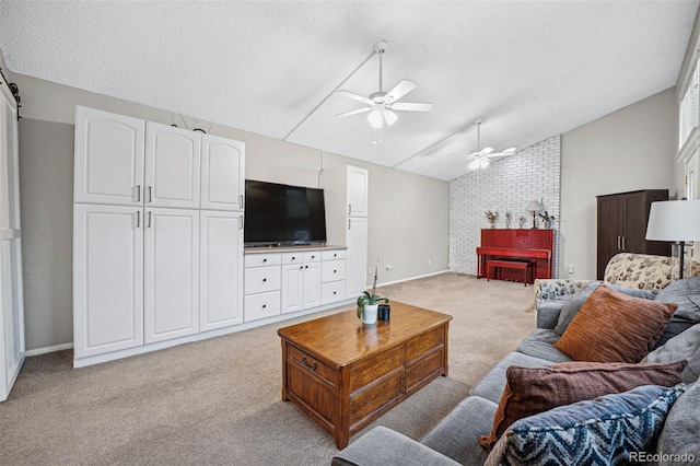 living room with ceiling fan, light colored carpet, lofted ceiling, and a textured ceiling