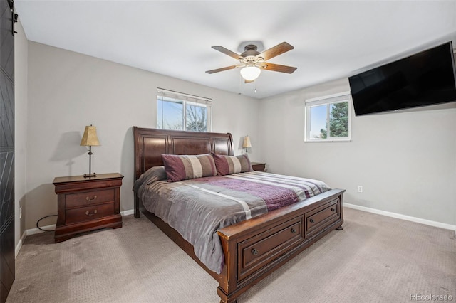 carpeted bedroom with ceiling fan and multiple windows