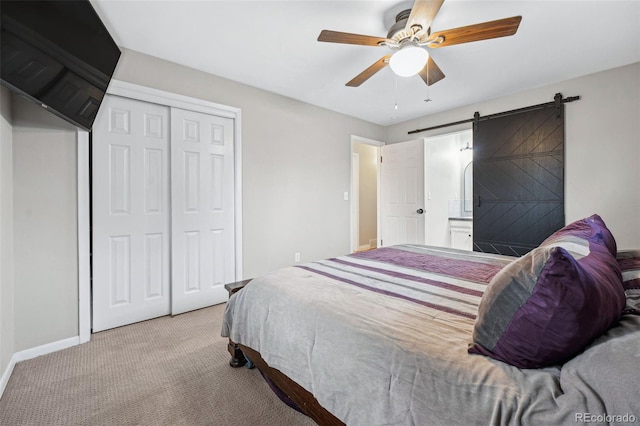 7636 S Eaton Way, Littleton, CO 80128 - bedroom featuring carpet flooring, a closet, ceiling fan, a barn door, and ensuite bath