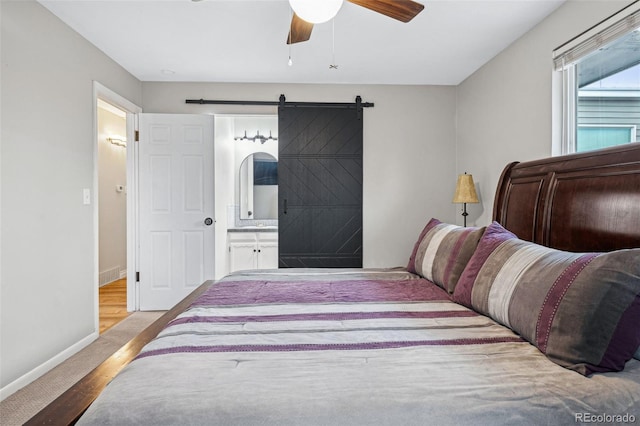 7636 S Eaton Way, Littleton, CO 80128 - bedroom with ensuite bathroom, a barn door, and a ceiling fan