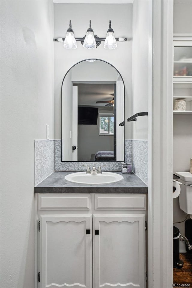 7636 S Eaton Way, Littleton, CO 80128 - ensuite bathroom with vanity and a ceiling fan