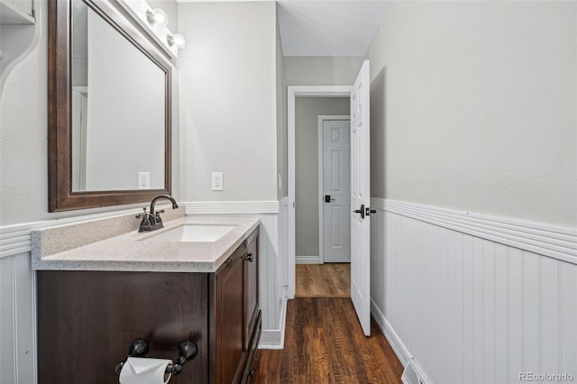 7636 S Eaton Way, Littleton, CO 80128 - bathroom featuring wainscoting, vanity, and wood finished floors