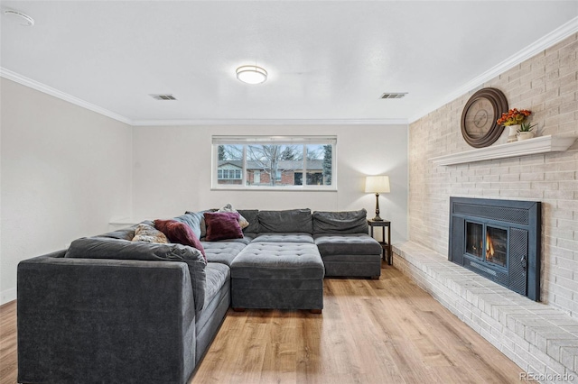 living room featuring a fireplace, light hardwood / wood-style floors, and ornamental molding