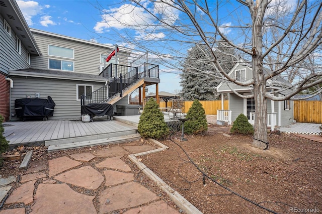 7636 S Eaton Way, Littleton, CO 80128 - view of yard featuring a wooden deck and stairs