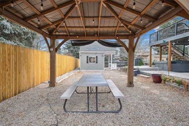 7636 S Eaton Way, Littleton, CO 80128 - view of patio featuring a gazebo, a hot tub, an outbuilding, and stairs