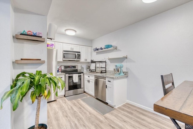 5300 E Cherry Creek S Drive 804, Denver, CO 80246 - kitchen with open shelves, stainless steel appliances, white cabinetry, and light wood finished floors