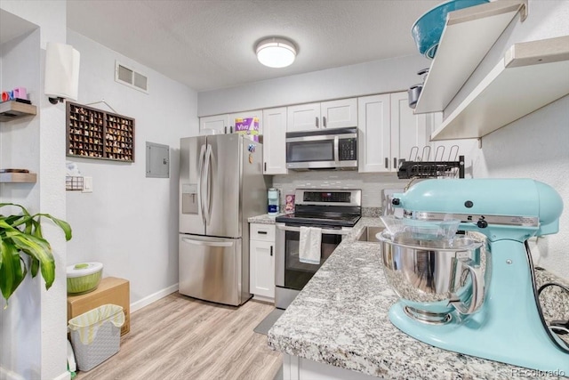 5300 E Cherry Creek S Drive 804, Denver, CO 80246 - kitchen with stainless steel appliances, light wood-type flooring, white cabinets, baseboards, and open shelves
