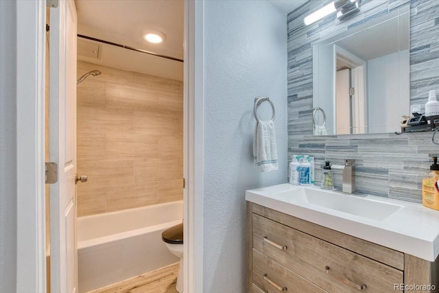 5300 E Cherry Creek S Drive 804, Denver, CO 80246 - full bath featuring a textured wall, vanity, toilet, shower / bath combination, and backsplash