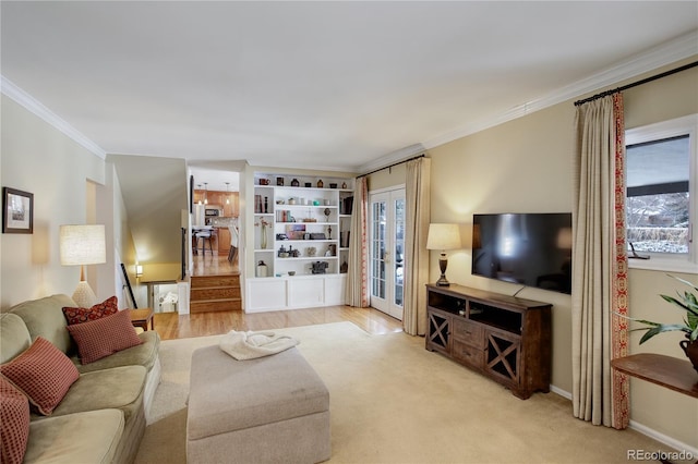 carpeted living room featuring french doors and ornamental molding