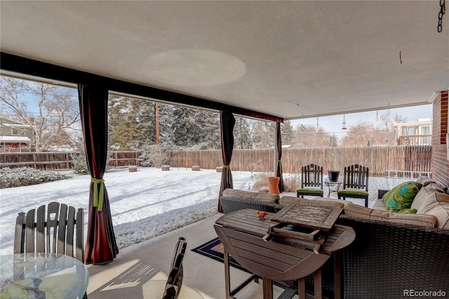 snow covered patio with outdoor lounge area