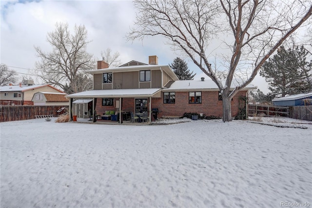 snow covered property with a porch