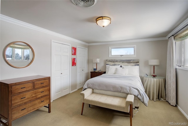 carpeted bedroom with multiple closets and ornamental molding