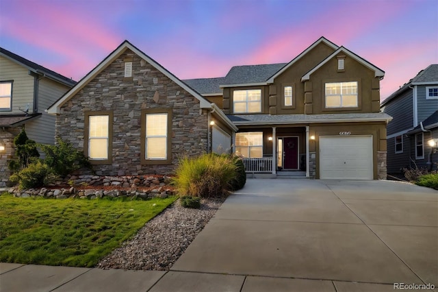 view of front of home with a garage, concrete driveway, and stucco siding