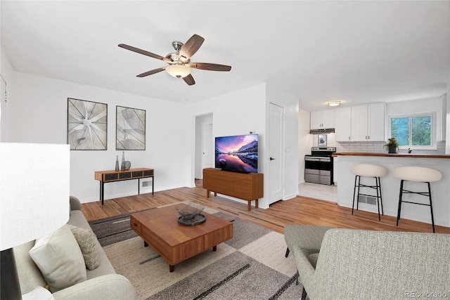 6765 W 33rd Ave, Wheat Ridge, CO 80033 - living area featuring light wood finished floors and ceiling fan