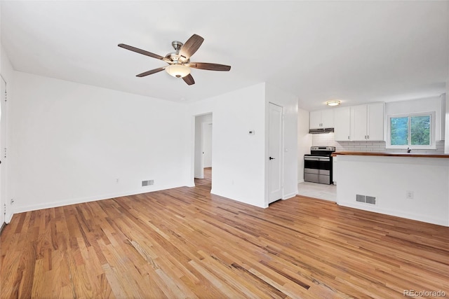 6765 W 33rd Ave, Wheat Ridge, CO 80033 - unfurnished living room with light wood finished floors and a ceiling fan