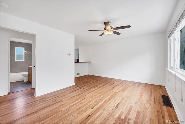 6765 W 33rd Ave, Wheat Ridge, CO 80033 - unfurnished room featuring healthy amount of natural light, ceiling fan, and light wood-type flooring