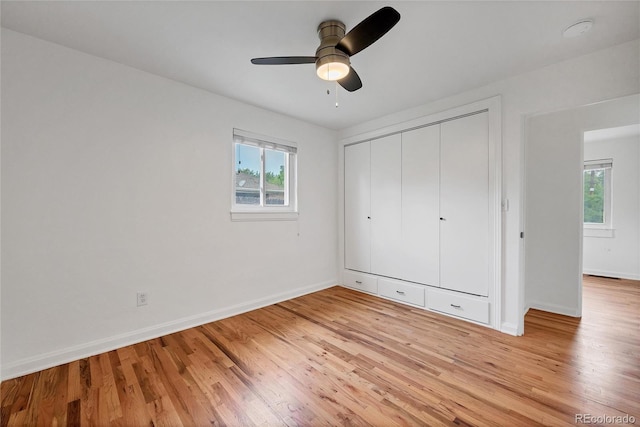 6765 W 33rd Ave, Wheat Ridge, CO 80033 - unfurnished bedroom with multiple windows, light wood-style floors, a closet, and a ceiling fan
