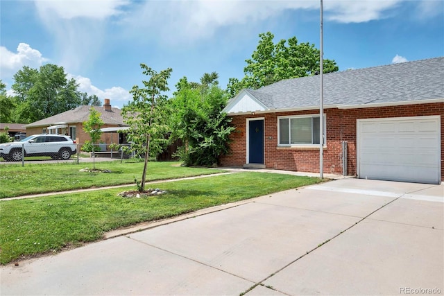 6765 W 33rd Ave, Wheat Ridge, CO 80033 - view of front of house featuring an attached garage, concrete driveway, brick siding, and roof with shingles