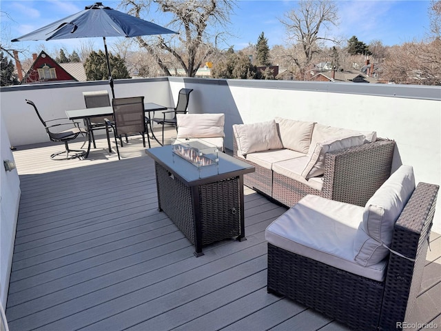 deck featuring an outdoor living space with a fire pit and outdoor dining space