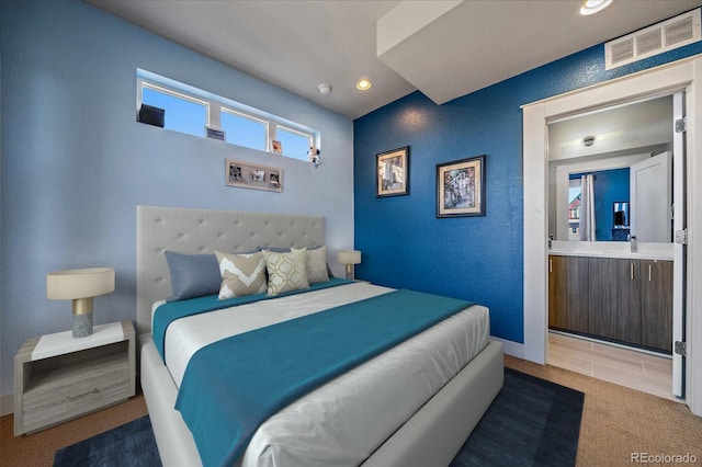 carpeted bedroom with recessed lighting, visible vents, and a textured wall