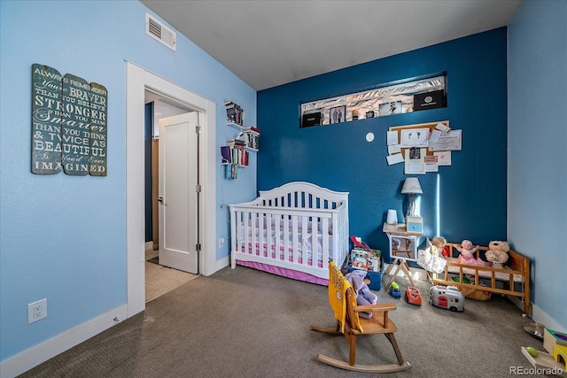 bedroom with visible vents, carpet floors, a nursery area, and baseboards