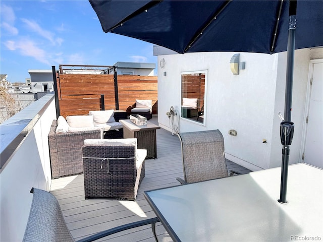 view of wooden balcony featuring an outdoor living space and a wooden deck