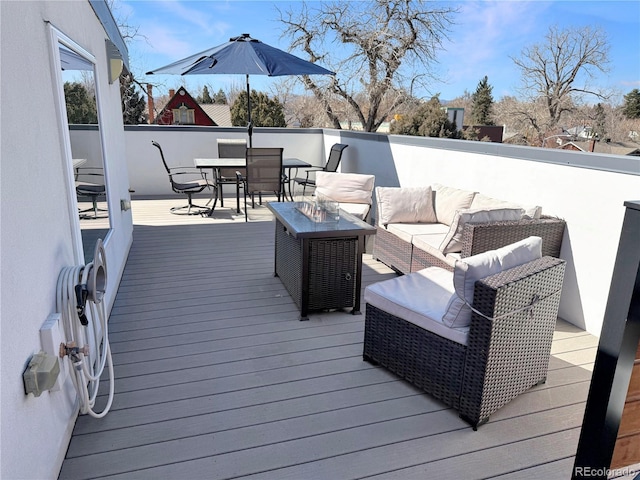 wooden deck featuring outdoor dining area and an outdoor hangout area