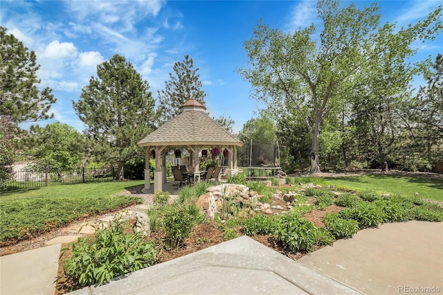 7472 S Utica St, Littleton, CO 80128 - view of yard with a gazebo, a patio area, a trampoline, and view of wooded area