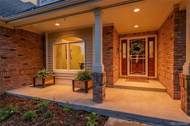 7472 S Utica St, Littleton, CO 80128 - property entrance featuring brick siding and a shingled roof