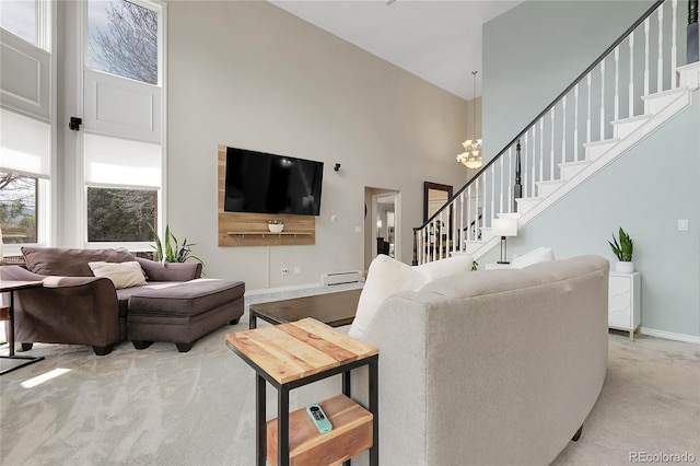 7472 S Utica St, Littleton, CO 80128 - living area featuring a towering ceiling, light colored carpet, a baseboard radiator, stairway, and a chandelier