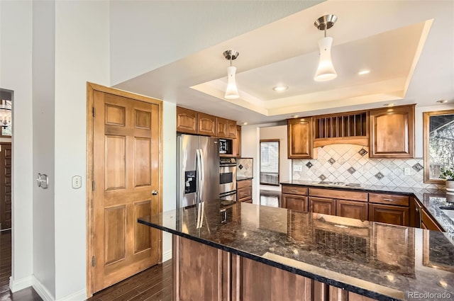 8159 Lodgepole Trl, Lone Tree, CO 80124 - kitchen featuring a tray ceiling, decorative backsplash, dark wood-type flooring, appliances with stainless steel finishes, and recessed lighting