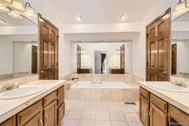 8159 Lodgepole Trl, Lone Tree, CO 80124 - bathroom featuring two vanities, a bath, and tile patterned floors