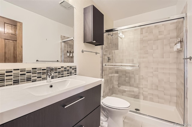 8159 Lodgepole Trl, Lone Tree, CO 80124 - bathroom featuring toilet, vanity, a shower stall, and decorative backsplash