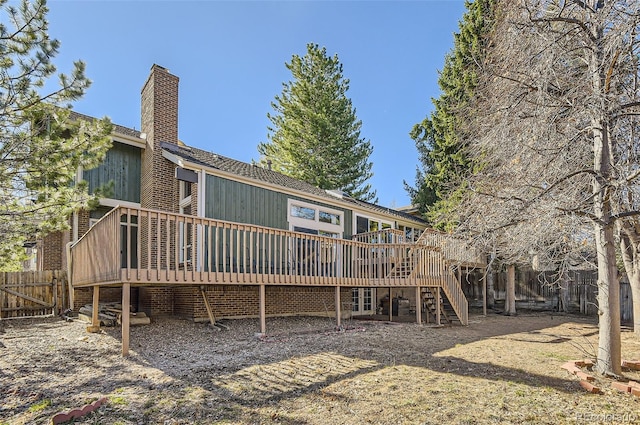 8159 Lodgepole Trl, Lone Tree, CO 80124 - rear view of house with stairs, a wooden deck, and a chimney
