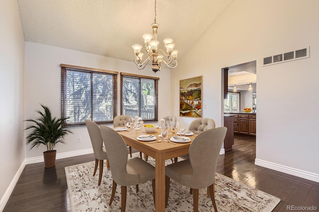 8159 Lodgepole Trl, Lone Tree, CO 80124 - dining room featuring a chandelier, vaulted ceiling, dark wood-style flooring, baseboards, and a textured ceiling