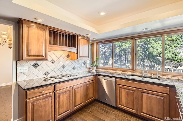 8159 Lodgepole Trl, Lone Tree, CO 80124 - kitchen featuring dishwasher, a sink, dark stone countertops, plenty of natural light, and recessed lighting