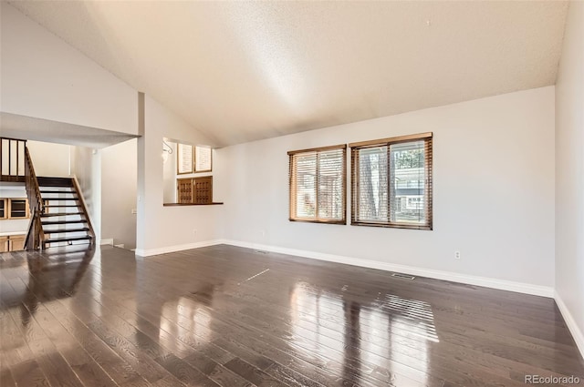 8159 Lodgepole Trl, Lone Tree, CO 80124 - unfurnished living room with vaulted ceiling, stairway, dark wood-style flooring, and baseboards