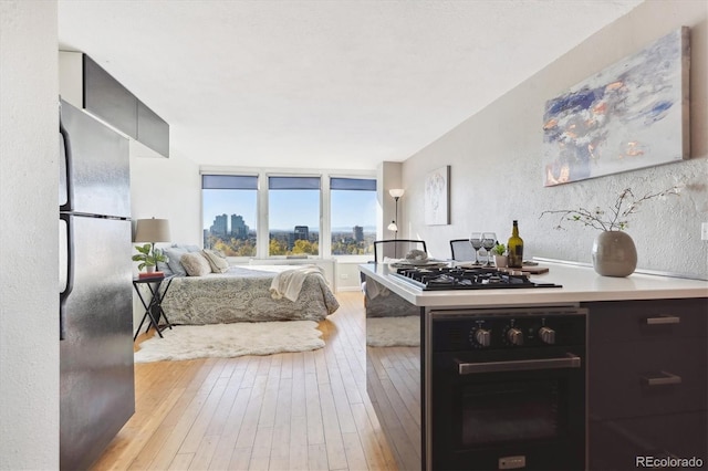kitchen featuring light wood-type flooring and black appliances