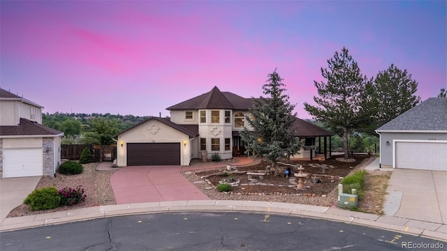 232 Crown High Ct, Colorado Springs, CO 80904 - view of front of house featuring concrete driveway, stucco siding, and an attached garage