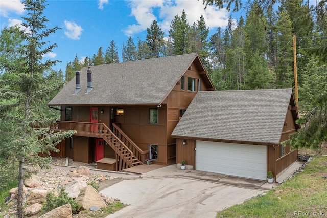 32462 Lodgepole Dr, Evergreen, CO 80439 - view of front of home with a shingled roof, stairs, driveway, and a chimney