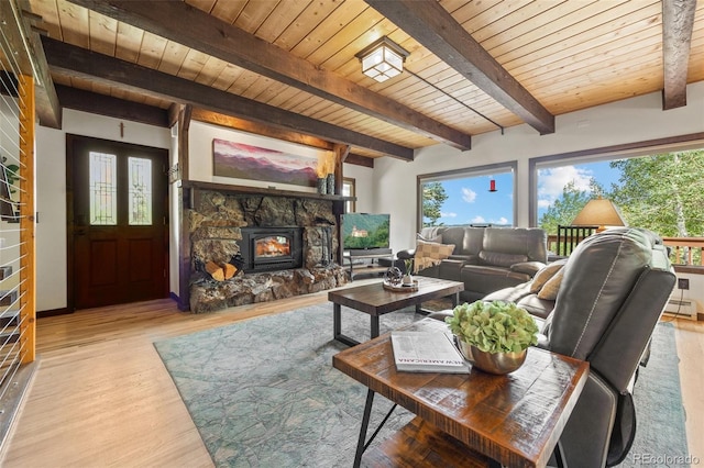 32462 Lodgepole Dr, Evergreen, CO 80439 - living room featuring a wooden ceiling with exposed beams, healthy amount of natural light, light wood-type flooring, and a fireplace