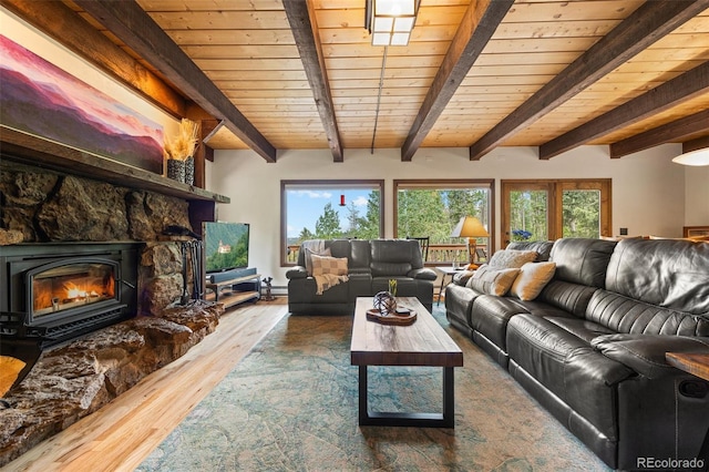 32462 Lodgepole Dr, Evergreen, CO 80439 - living room with wood finished floors, a wooden ceiling with exposed beams, a baseboard heating unit, and a fireplace