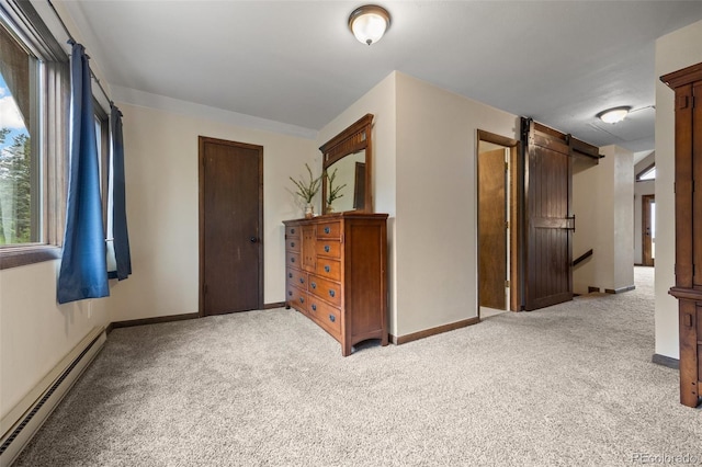 32462 Lodgepole Dr, Evergreen, CO 80439 - unfurnished bedroom featuring baseboard heating, carpet, and a barn door