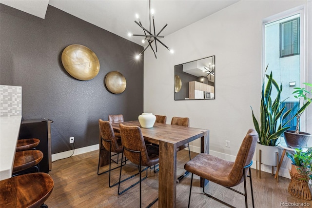 dining space featuring dark hardwood / wood-style flooring and a notable chandelier