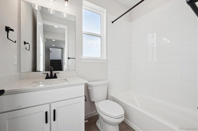 full bathroom featuring vanity, toilet, washtub / shower combination, and a wealth of natural light