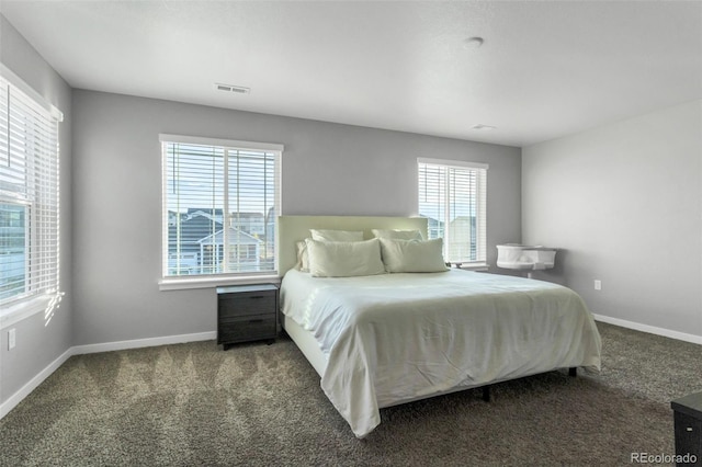 bedroom featuring carpet floors, visible vents, and baseboards